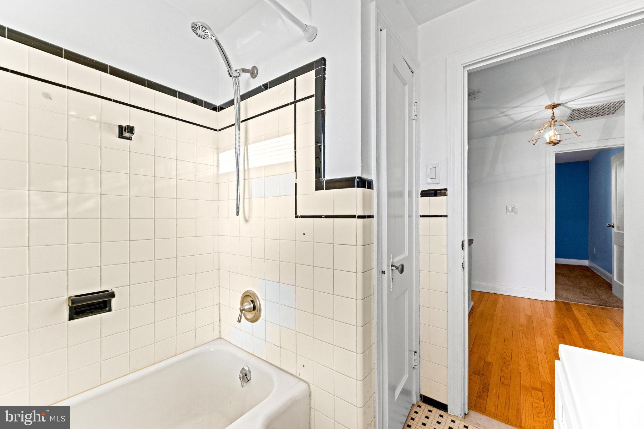 3807 Kimble Road Baltimore, MD 21218 - Photo 25 of 39 a bathroom with a bathtub and a shower