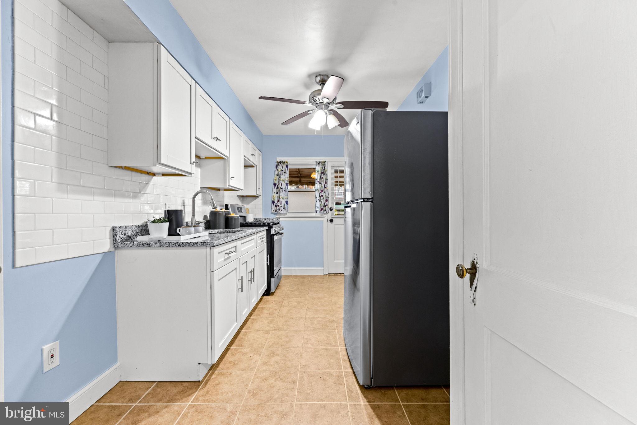 3807 Kimble Road Baltimore, MD 21218 - Photo 10 of 39 a kitchen with a refrigerator and cabinets