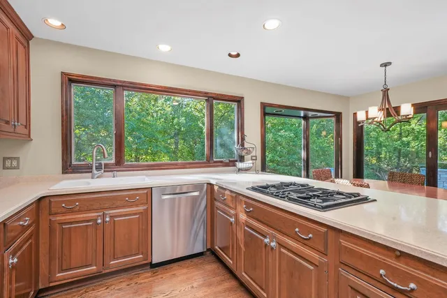 a kitchen with granite countertop sink stove and refrigerator