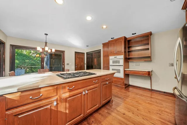 a kitchen with stainless steel appliances granite countertop a stove and a wooden cabinets