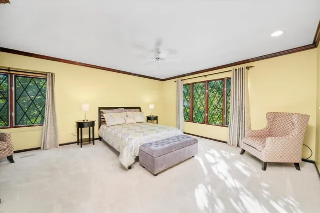 a spacious bedroom with a large bed and a large window