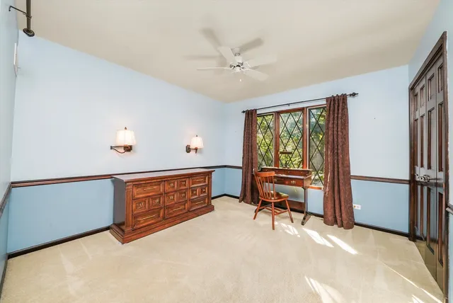 a view of room with workspace and windows