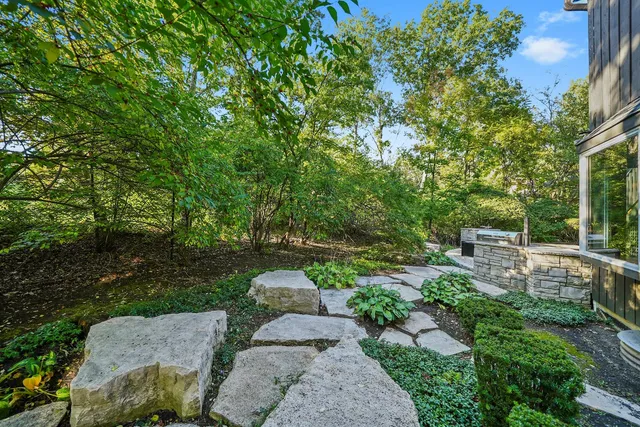 a view of backyard with outdoor seating and green space