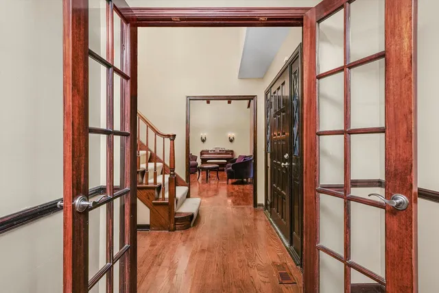 a view of a hallway with wooden floor and staircase