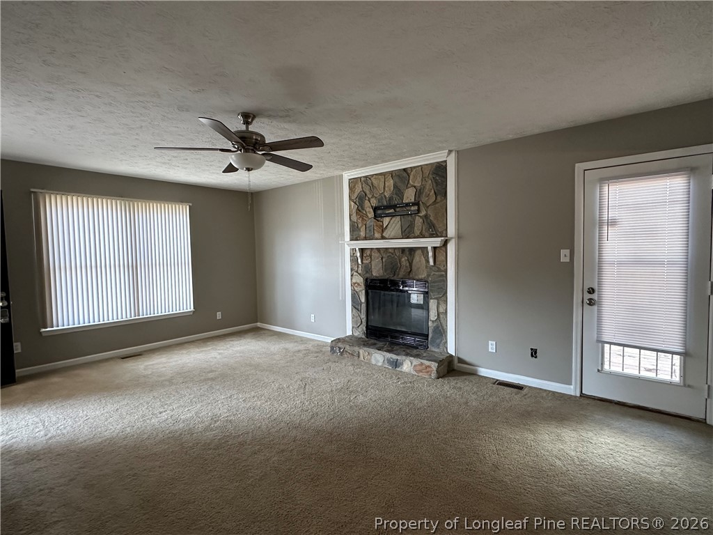 2678 Rivercliff Road Fayetteville, NC 28301 - Photo 4 of 19 an empty room with windows and ceiling fan