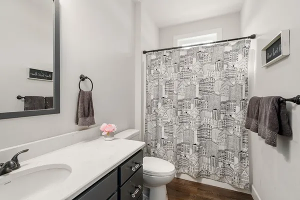 a bathroom with a sink toilet and shower