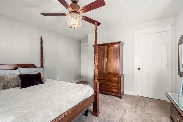 a bedroom with a bed and a chandelier