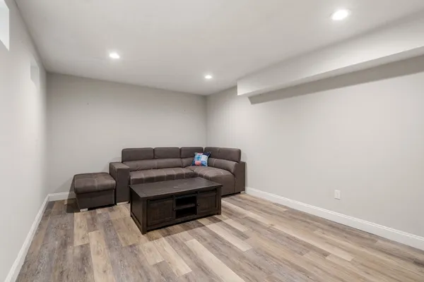 a living room with furniture and a wooden floor
