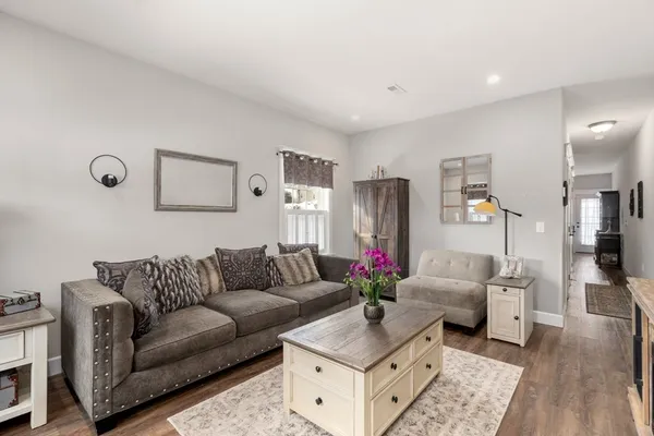 a living room with furniture and wooden floor