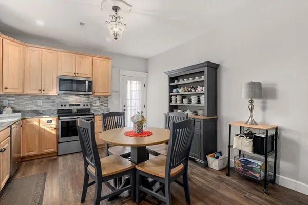a kitchen with a dining table and chairs