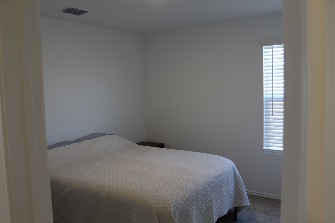 205 Marty Allen Loop Jarrell, TX 76537 - Photo 15 of 22 a bedroom with a bed and a window