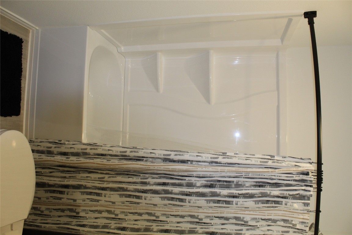 205 Marty Allen Loop Jarrell, TX 76537 - Photo 17 of 22 a bathroom with a shower and a toilet