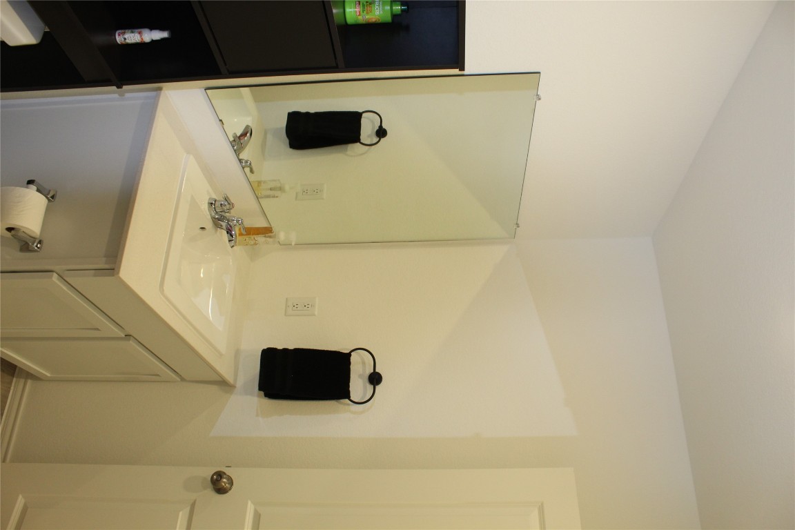 205 Marty Allen Loop Jarrell, TX 76537 - Photo 18 of 22 a bathroom with a sink and a mirror