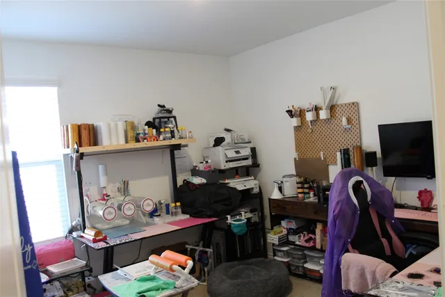 a bedroom with a bed and a tv