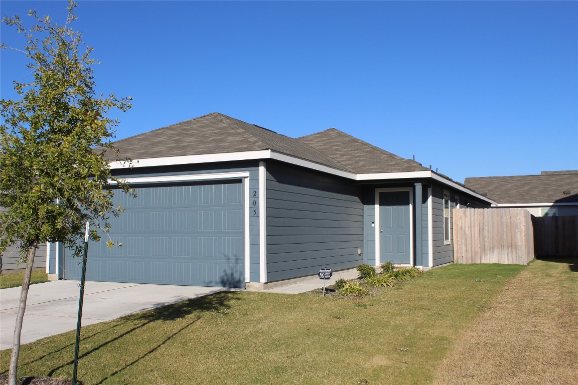 205 Marty Allen Loop Jarrell, TX 76537 - Photo 2 of 22 a front view of a house with a garage