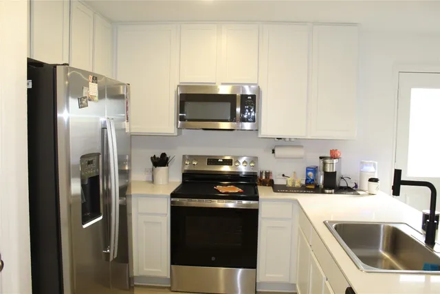 a kitchen with a sink and a refrigerator
