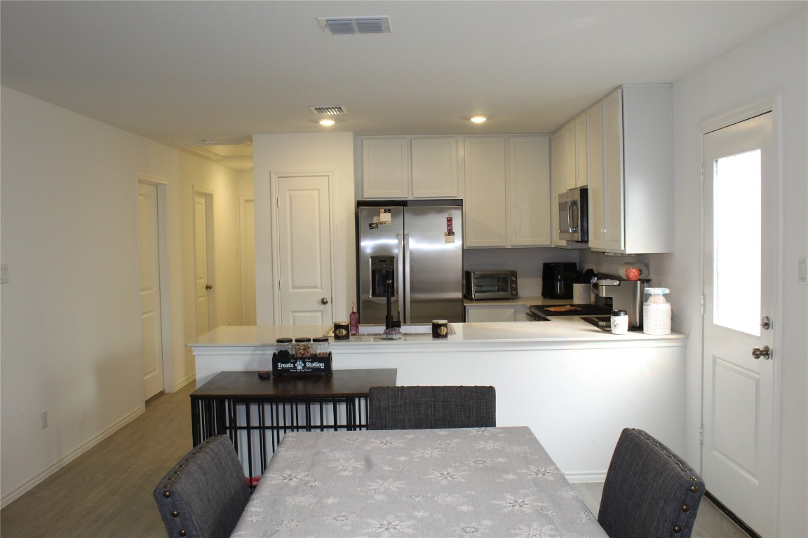 205 Marty Allen Loop Jarrell, TX 76537 - Photo 7 of 22 a kitchen with kitchen island a sink stove and refrigerator