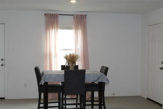 a view of a dining room with furniture and a potted plant