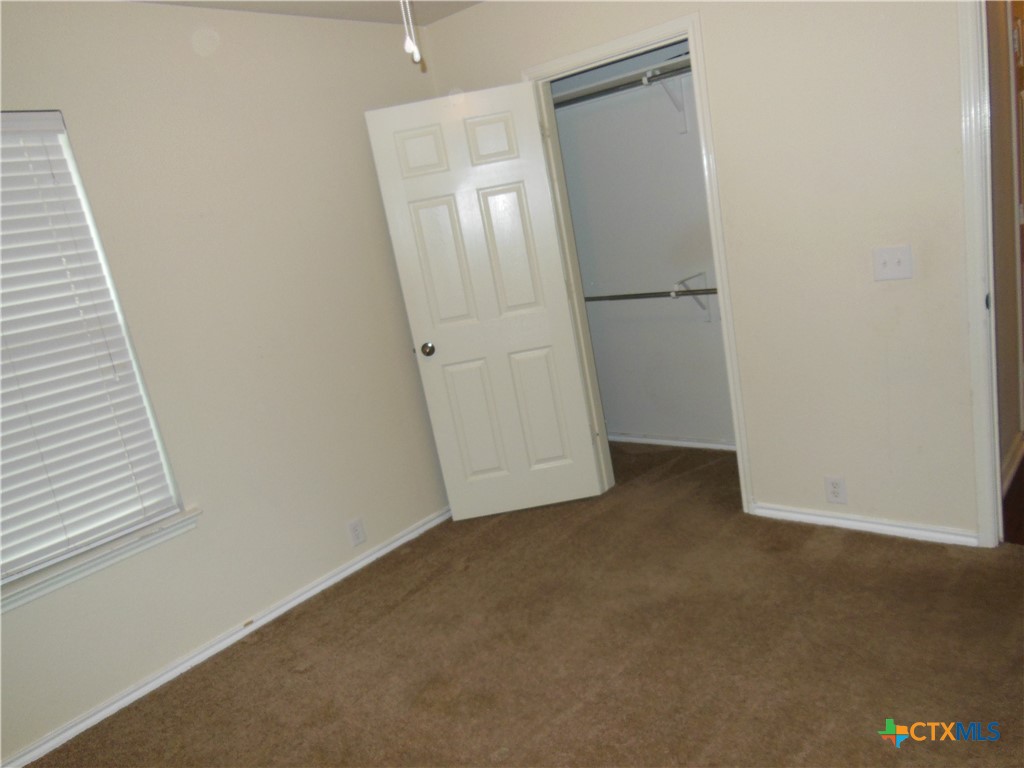 5244 Brookline Schertz, TX 78108 - Photo 14 of 24 an empty room with wooden floor and mirror