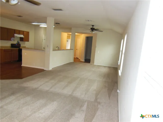 a view of a big room with a kitchen