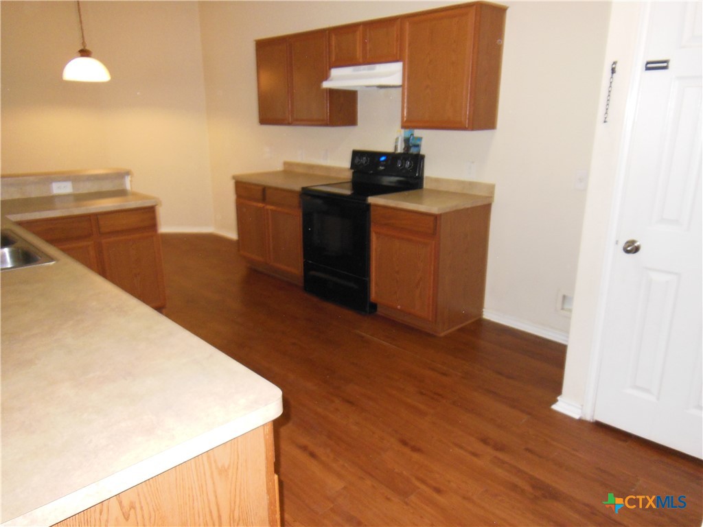 5244 Brookline Schertz, TX 78108 - Photo 7 of 24 a kitchen with stainless steel appliances wooden cabinets and wooden floor