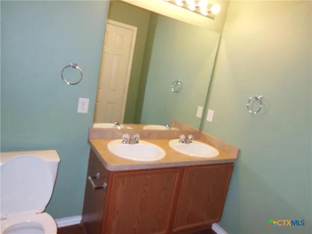 a bathroom with a toilet sink and mirror