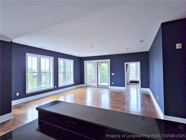 a view of room with window and hardwood floor