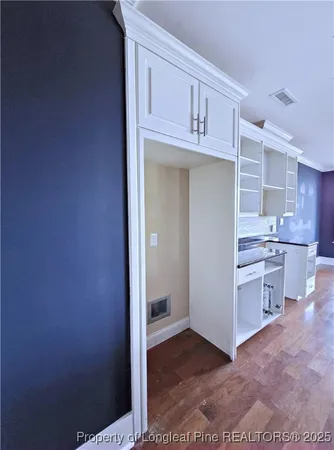 a view of cabinets and wooden floor