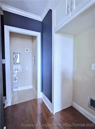a view of a hallway with wooden floor