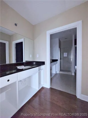 a large white kitchen with a sink and cabinets
