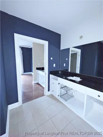 a bathroom with a sink a mirror and a shower
