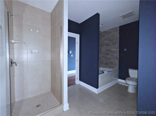 a bathroom with a bathtub and a toilet