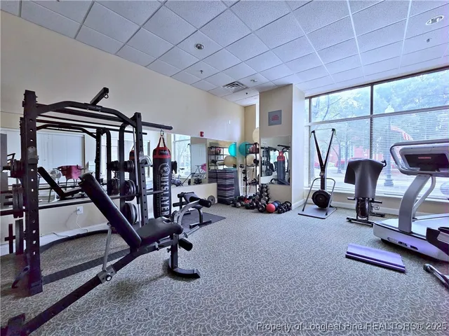 a front view of a building with a garden and plants