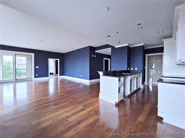 a view of kitchen with cabinets and wooden floor