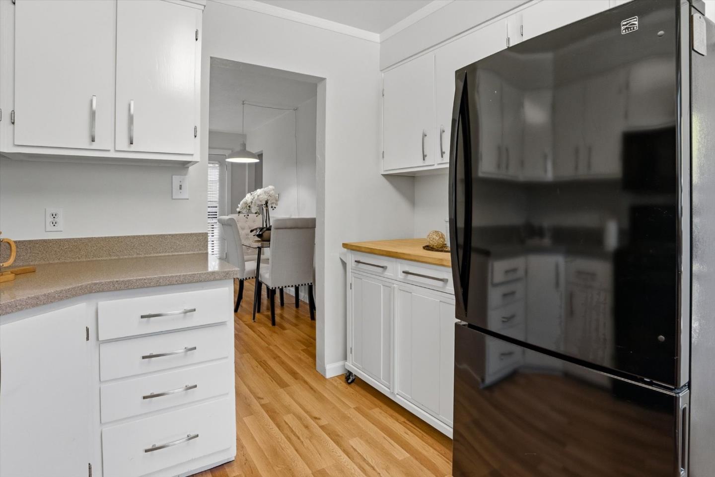 16899 Kennedy Road Los Gatos, CA 95032 - Photo 14 of 61 a kitchen with a refrigerator and white cabinets