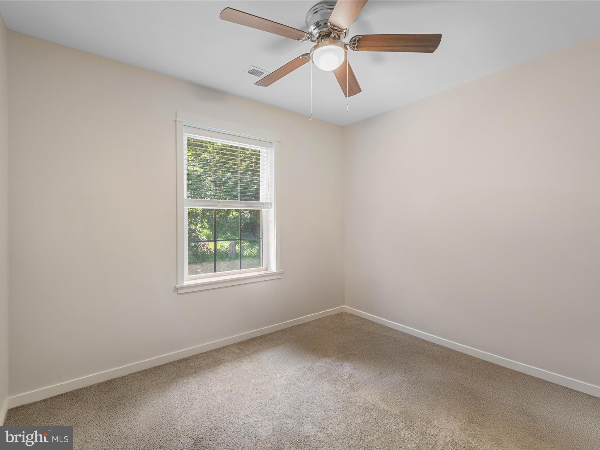 231 Greenfield Road Front Royal, VA 22630 - Photo 27 of 38 an empty room with a window and a fan