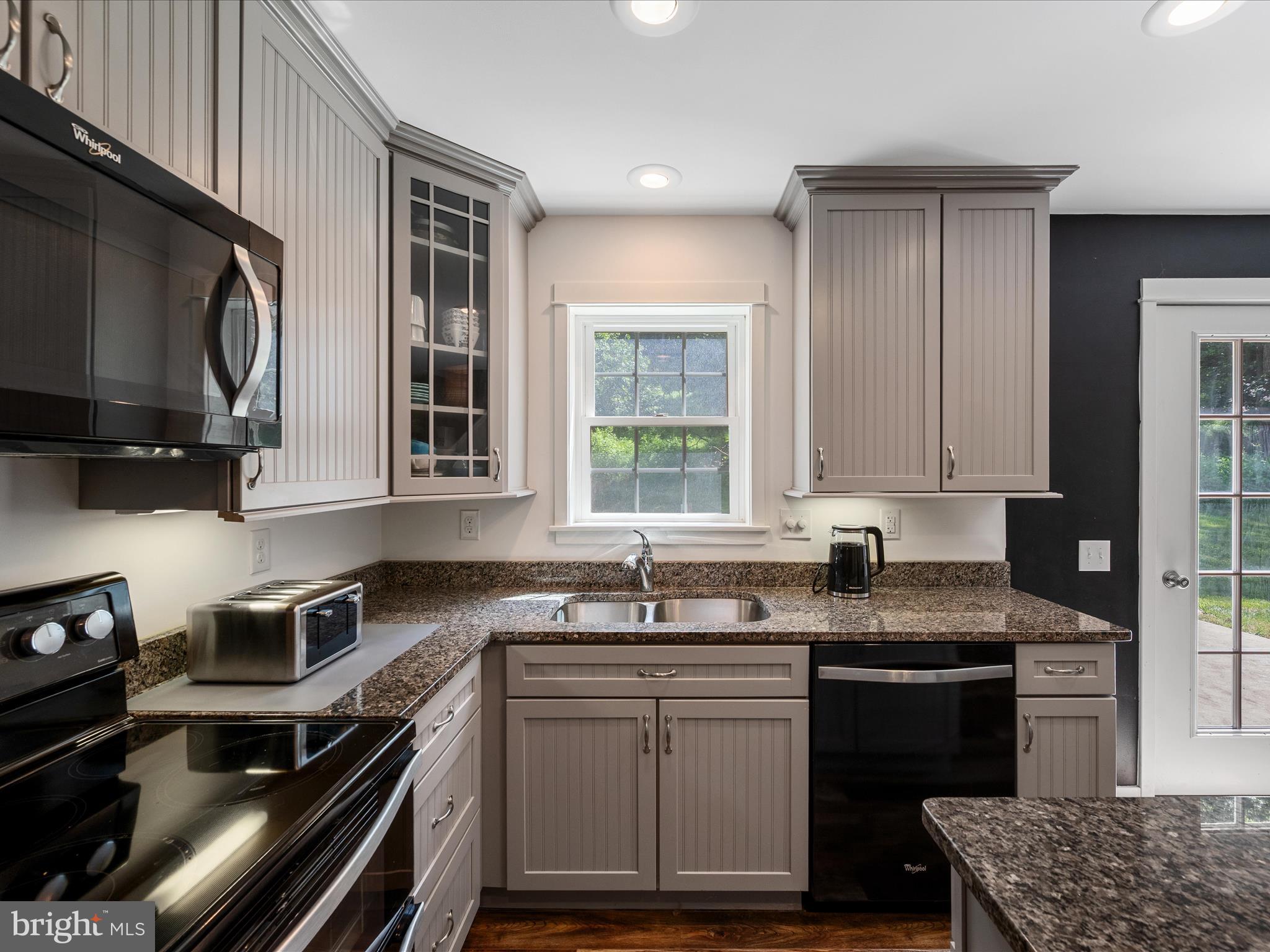 231 Greenfield Road Front Royal, VA 22630 - Photo 10 of 38 a kitchen with granite countertop a sink stove and cabinets