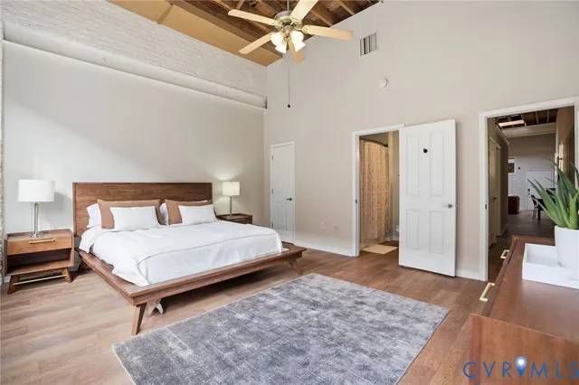 a bedroom with a bed and wooden floor