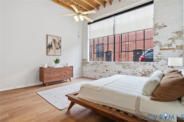 a bedroom with a bed and a window