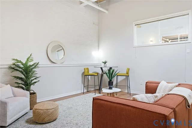 a living room with furniture and potted plant