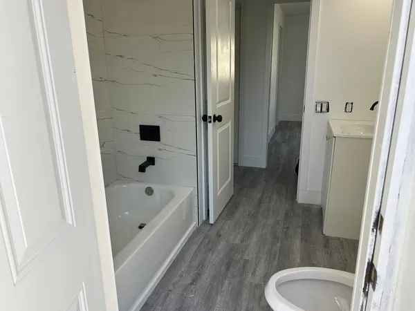 a bathroom with a tub toilet and sink