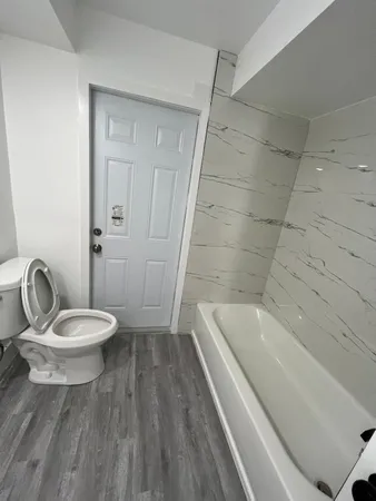 a bathroom with a toilet a sink and bathtub