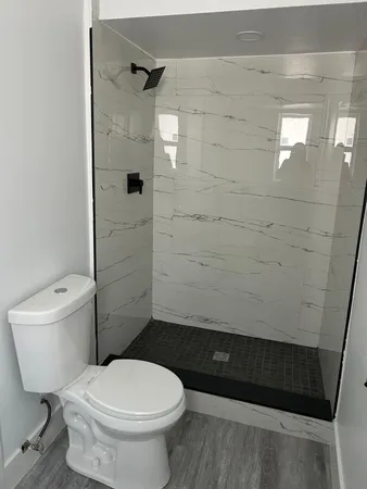 a bathroom with a toilet and a shower