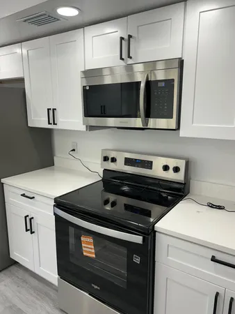 a kitchen with a stove and a microwave
