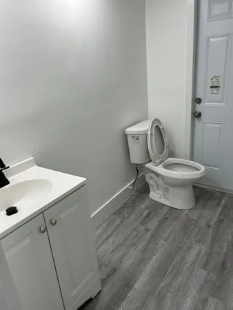 a white toilet sitting next to a bathroom sink