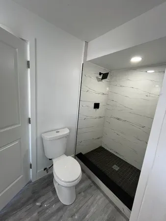 a bathroom with a toilet and a shower
