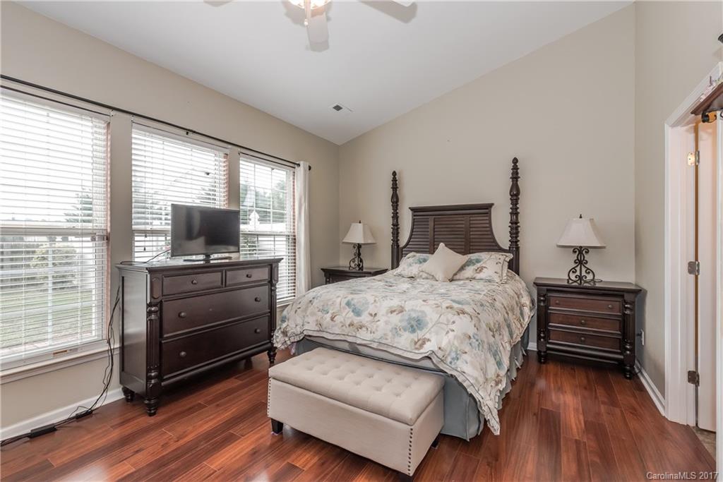 2531 Fossil Stone Lane Fort Mill, SC 29708 - Photo 12 of 21 a bedroom with a bed and wooden floor