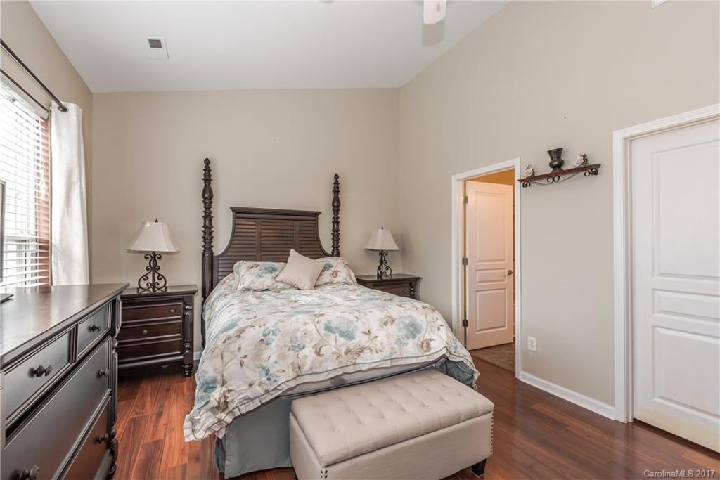 2531 Fossil Stone Lane Fort Mill, SC 29708 - Photo 13 of 21 a bedroom with a bed and wooden floor