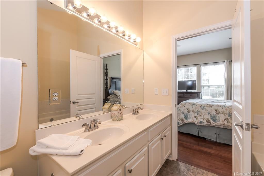 2531 Fossil Stone Lane Fort Mill, SC 29708 - Photo 15 of 21 a en suite bathroom with a double vanity sink and a mirror