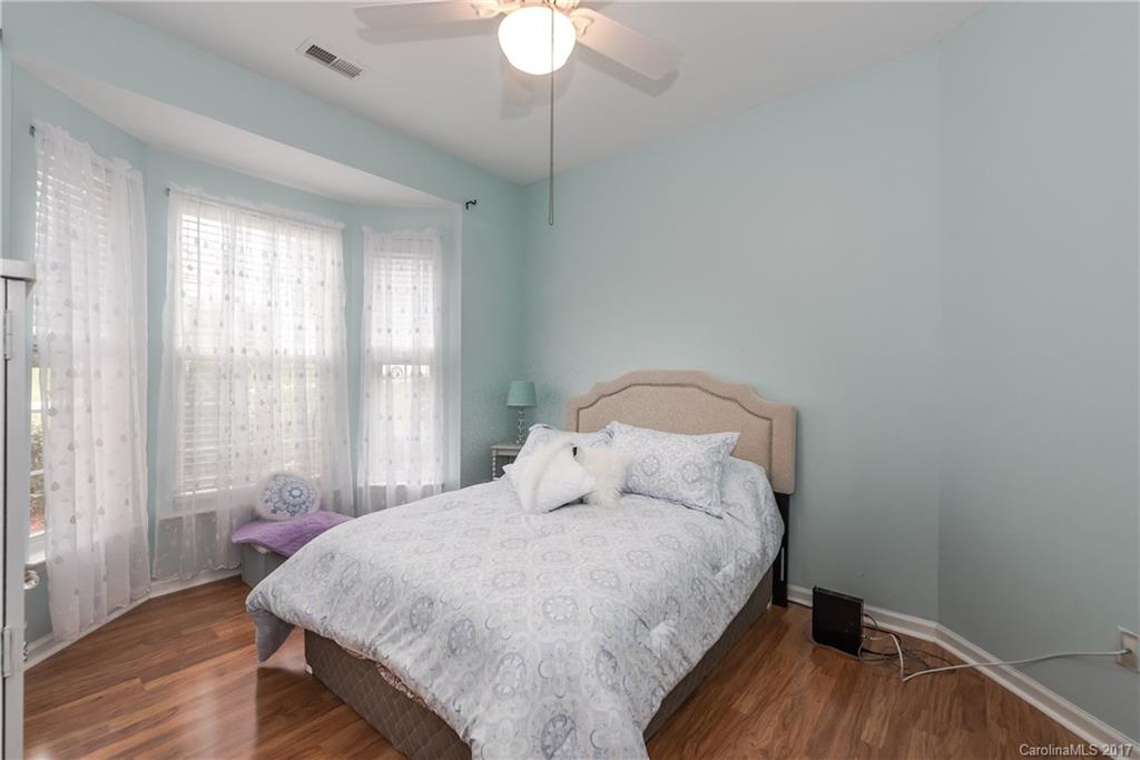 2531 Fossil Stone Lane Fort Mill, SC 29708 - Photo 17 of 21 a bedroom with a bed and a chandelier